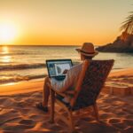 Person achieving financial freedom, sitting on a beach with a laptop and a cocktail, enjoying the benefits of passive income